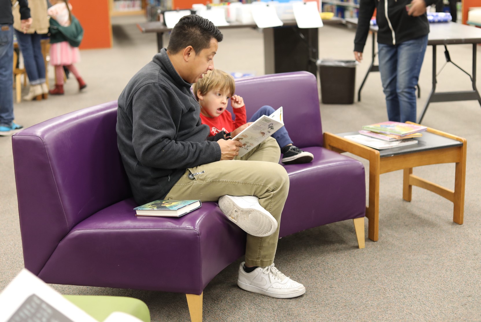 parent child reading on sofa