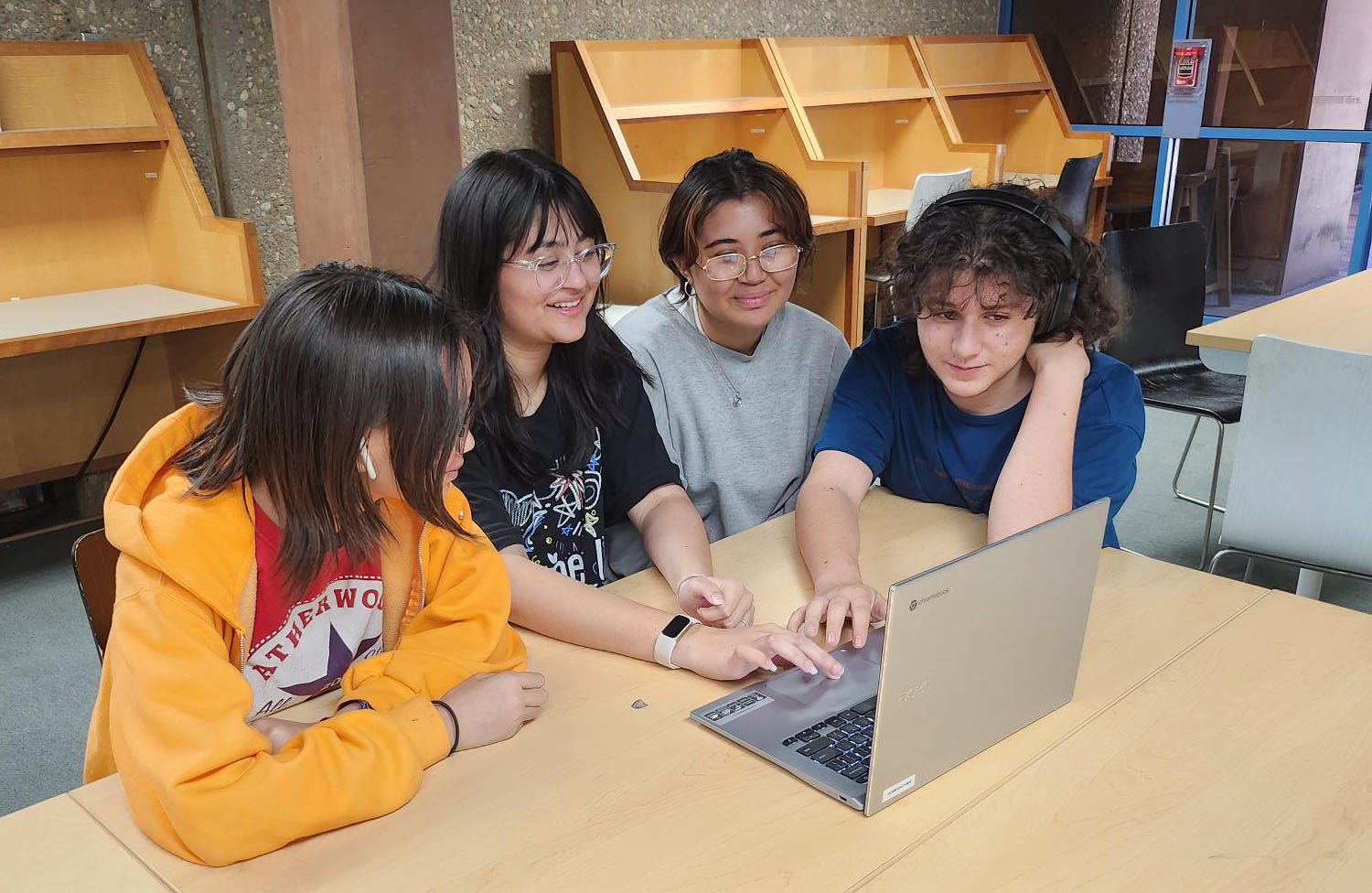 Teen group using laptop